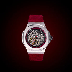 Watch with red strap and visible mechanism on a dark background