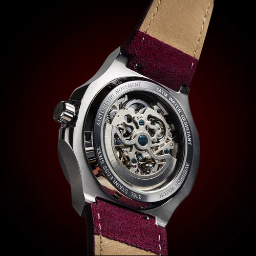 Watch with a burgundy strap on a dark background