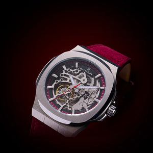 Luxury watch with red strap on a dark background